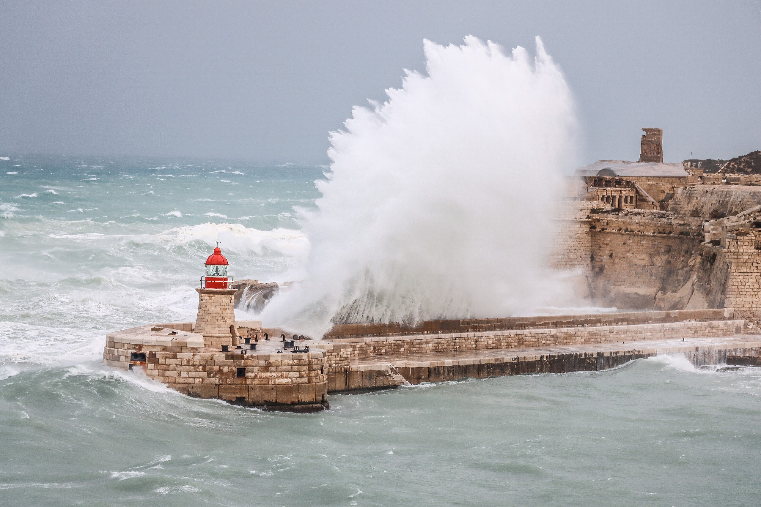 A huge wave hitting the breakwater at Fort Ricasoli, Malta
